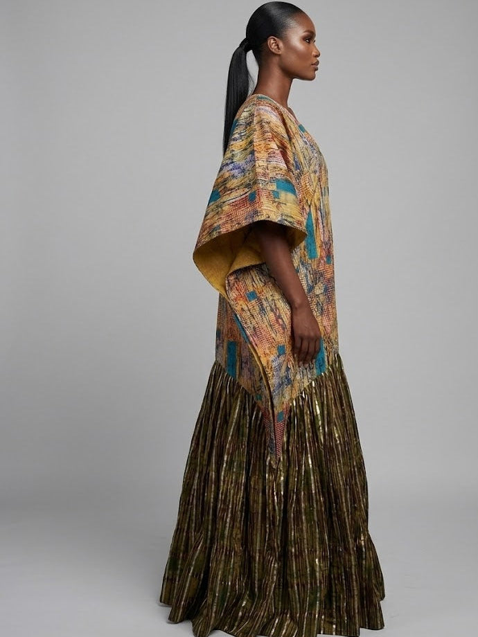 Woman wearing a colorful patterned dress with a plain background